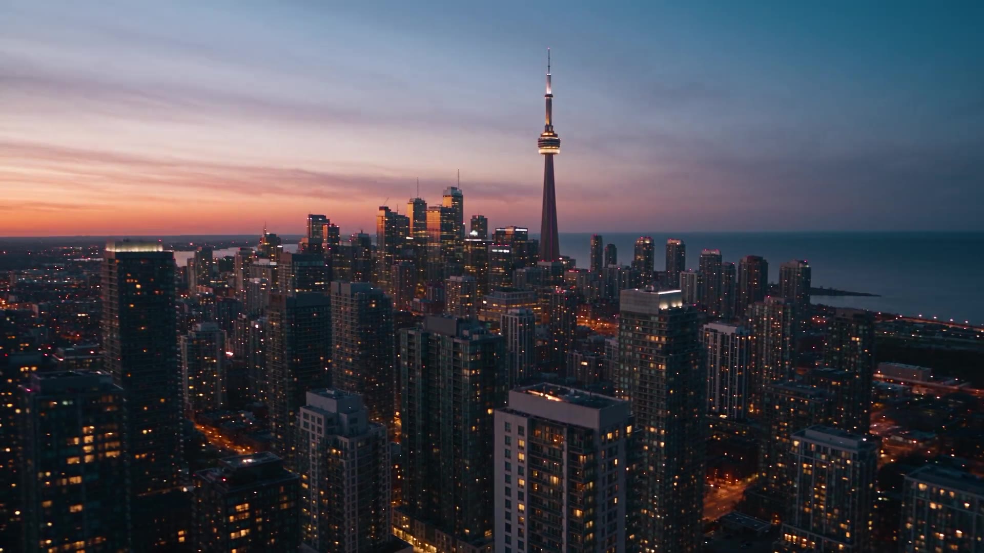 Aerial view of Toronto's condo towers and the CN Tower at sunset.